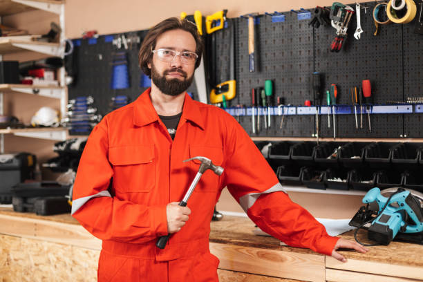 istock Foreman in orange work clothes and protective eyewear holding ha 1357758237