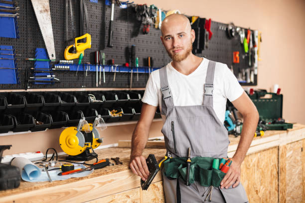 istock Foreman in work clothes holding stapler in hand thoughtfully loo 1357759497