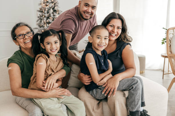 istock Smiling family sitting on sofa all vaccinated 1357759614