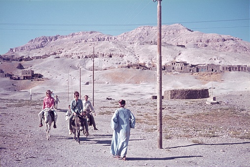 Luxor, Egypt, 1969. Tourists ride donkeys towards the Valley of the Kings. Also: locals.
