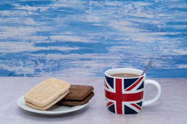 istock British mug with a custard cream and chocolate bourbon cookie 1357761644
