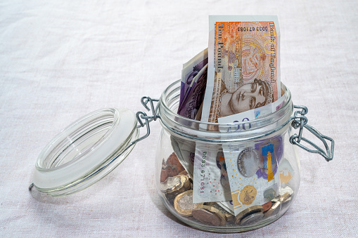 British money stored in a glass jar