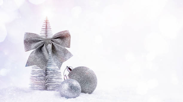 istock Decorative silver Christmas tree with shiny balls for the Christmas tree on light background.New Year's card background.Copy space.New Year concept.Background for congratulations.Simple minimalistic. 1357762990