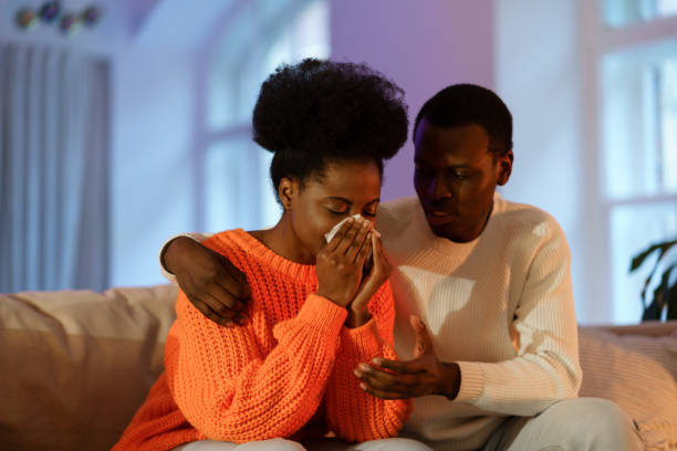 istock Relationship problems. Sad african woman with handkerchief crying after arguing with husband 1357764098