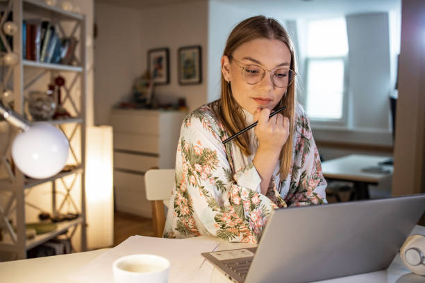 istock Young woman concentrating on her work at home 1357770405