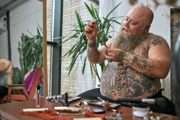 transgender tattoed man a room with cosmetics