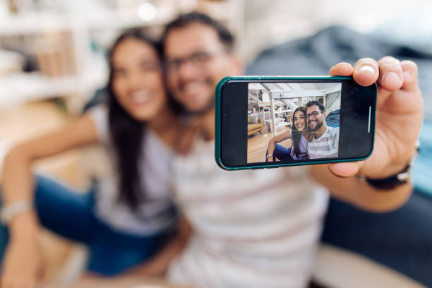 istock Happy couple taking a selfie at their bedroom 1357773211