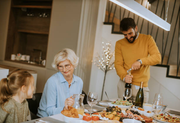 istock Young man opening bottle of red wine during at home 1357777236