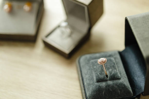 istock Diamond ring in jewelry gift box on wood table 1357785672