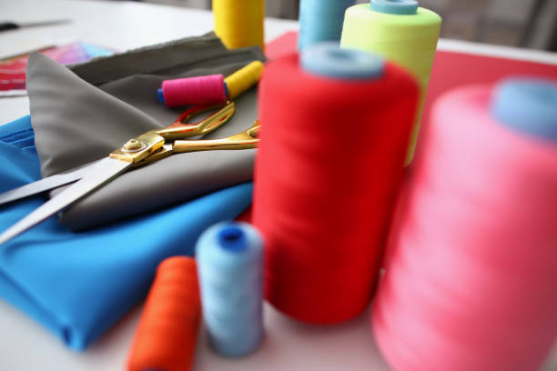 istock Composition of sewing accessories scissors and threads on fabric 1357786158