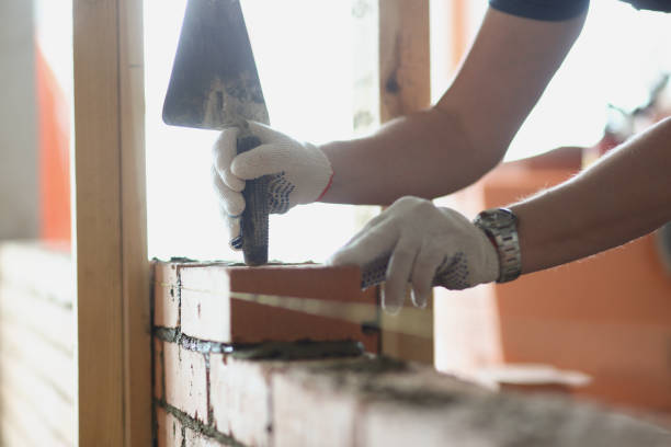 istock Foreman use special tool working with brick building wall in room 1357786162