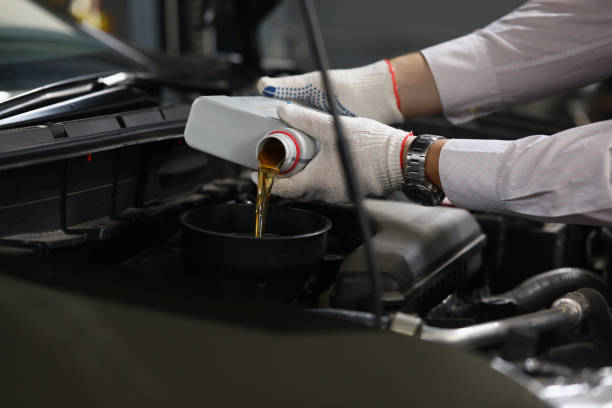 istock Refueling and pouring oil quality into engine motor car 1357786180