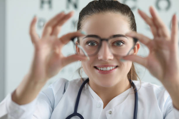 istock Woman eye doctor with eye test chart on background 1357786192