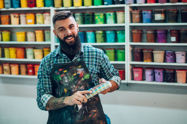 istock Male worker mixing colors for screen printing in a workshop 1357786295