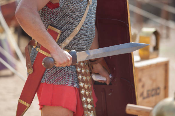 istock Roman soldier wielding a wooden training sword 1357787262