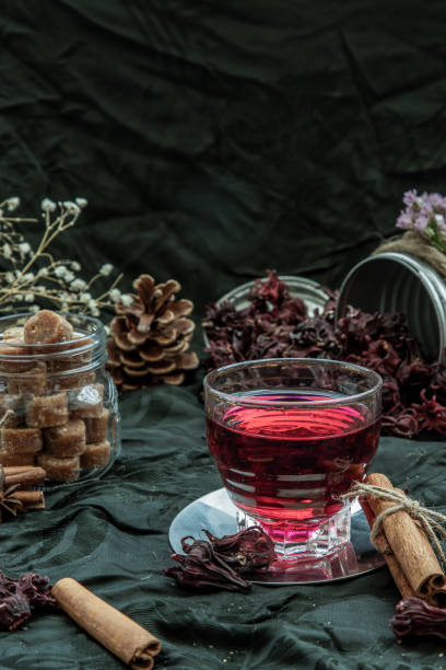 Roselle tea (Jamaica sorrel, Rozelle or hibiscus sabdariffa ) with dry roselle and brown cane sugar cube.