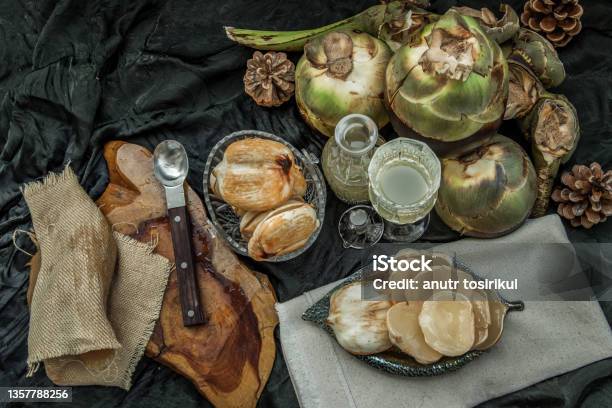 Peel Toddy Palm And Fresh Palm Juice At Front Of Dark Background Stock Photo - Download Image Now