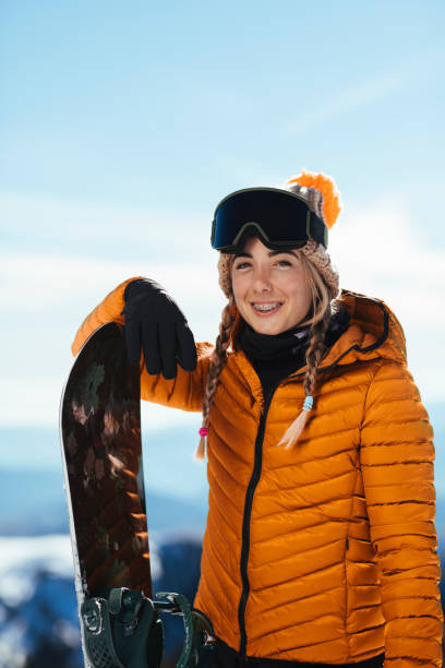istock It's always smiles with her when it comes to snowboards 1357791128