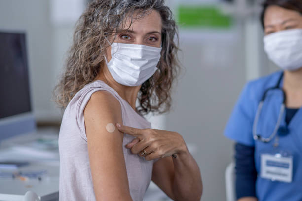 istock Patient Showing She Received Her Vaccine 1357793161