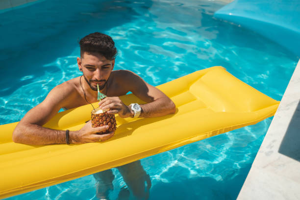 Manluck Pool 50+ Wet Young Man Drinking Cocktail At Swimming Pool Stock Photos ...