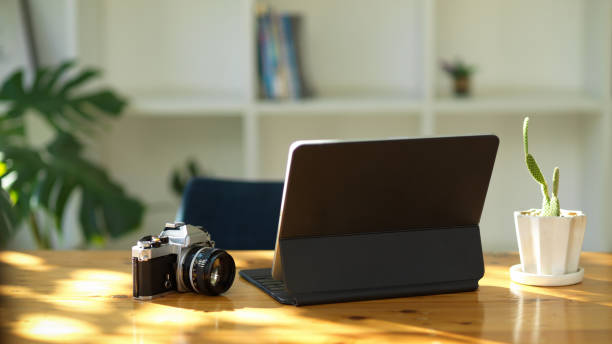 istock Close-up Portable digital tablet computer or touchpad, camera and on wooden table 1357800087