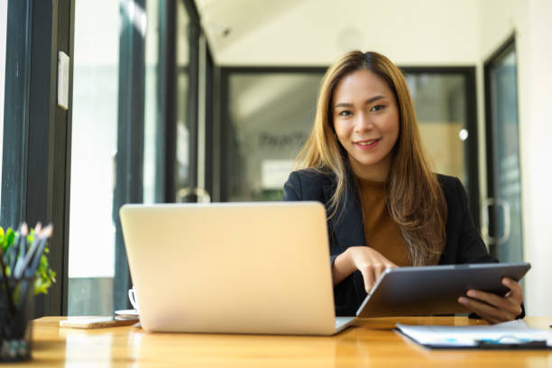 istock Female business employee working at her desk 1357800116