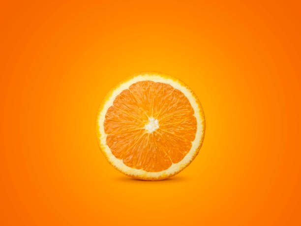 istock One orange fruit slice on bright background in orange color. A saturated citrus texture image 1357800237