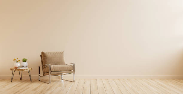 istock Modern minimalist interior with an armchair on empty cream color wall background. 1357802059