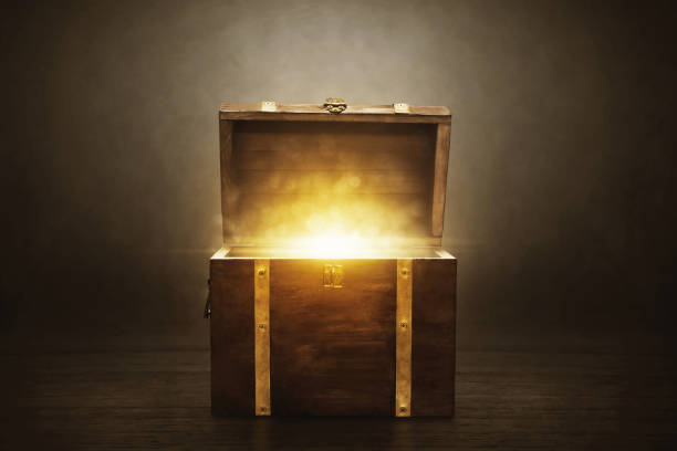 istock Wooden treasure chest on dark background 1357808573