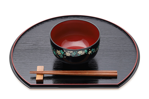 Miso soup bowl with chopsticks on tray, Traditional tableware of Japan. Isolated on white background