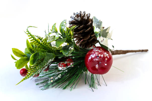 istock Christmas branch with berries and cone covered with snow close-up 1357815010