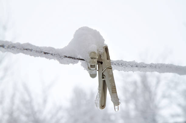 Winter abstraction. Clothespins covered with snow and ice.