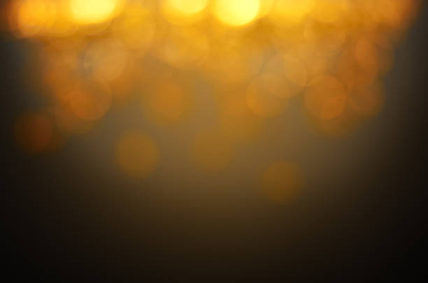 istock blurry yellow lights on a dark background 1357816205
