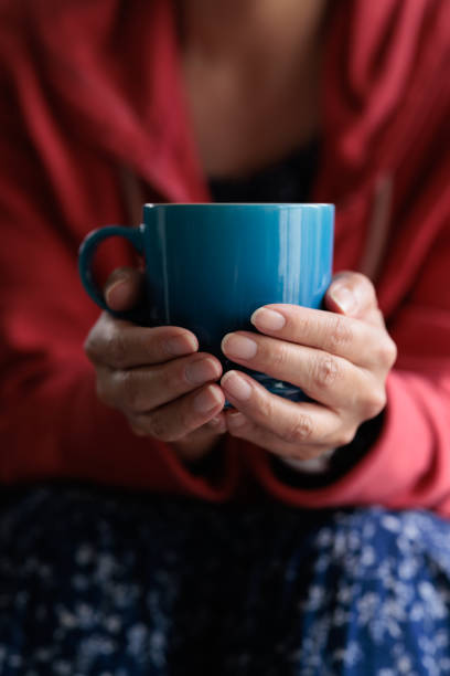 istock Coffee cup being held by a woman 1357816585