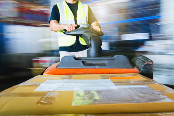istock Motion Blur of Workers Unloading Package Boxes in the Warehouse. Supply Chain. Storage Warehouse Shipping Cargo Warehouse Logistics. 1357817665