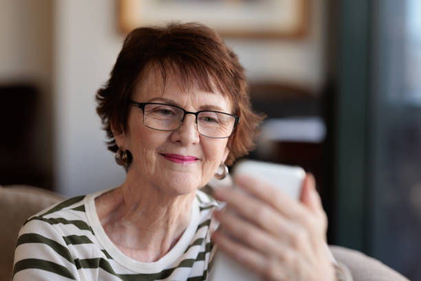 istock Smiling woman using her phone 1357818403