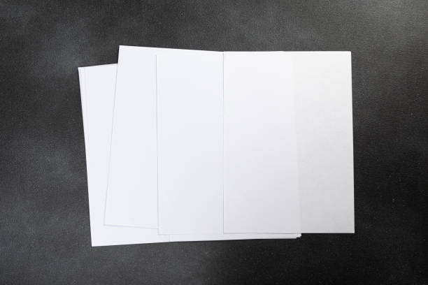 istock White business card sheet of paper a4 stack on a dark table. Clean portrait A4. 1357819696