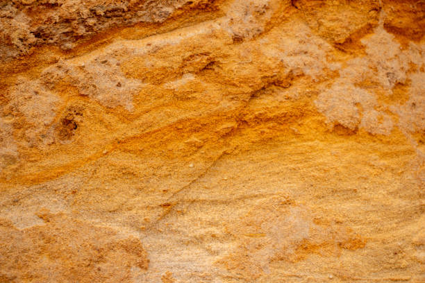 istock Textural sand, with  relief surface, multi-colored layers and different in size of granules, in outdoor sand career, after mining ore and sand for construction. 1357819982