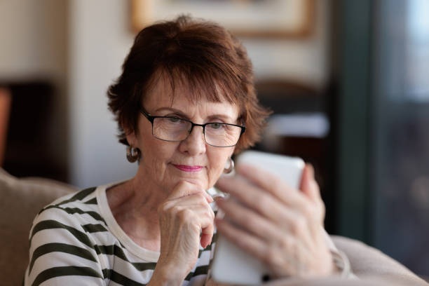 istock Smiling woman using her phone 1357820775