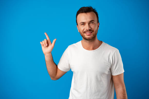 istock Male customer presenting new product, pointing finger at copy space 1357821308