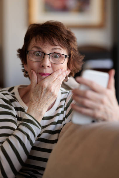 istock Woman looking at her phone with a surprised expression 1357825009