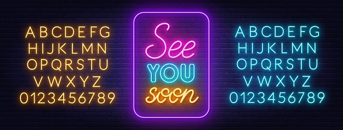 See You Soon neon lettering on brick wall background. Yellow and blue neon alphabets.