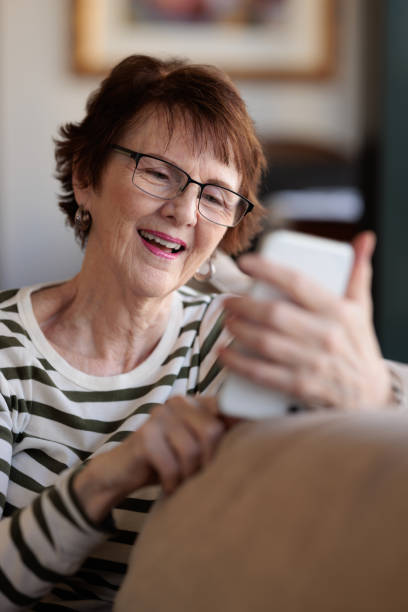 istock Smiling woman using her phone 1357827409