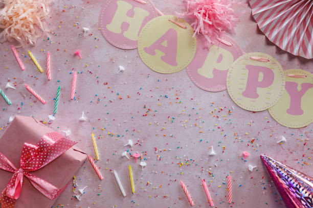 istock Birthday present and party accessories on pink background 1357827596