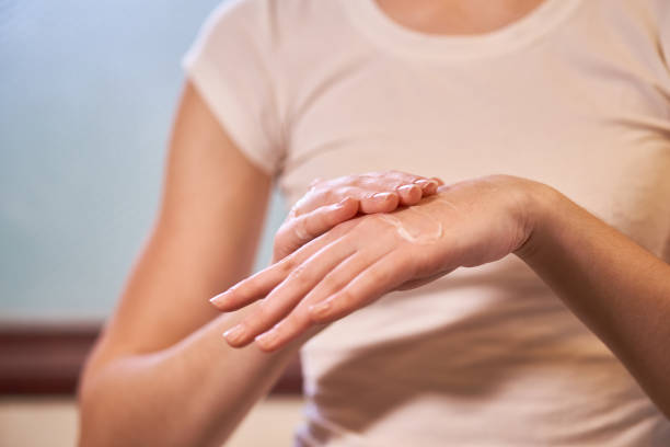 istock Woman applying lotion on hands 1357827713