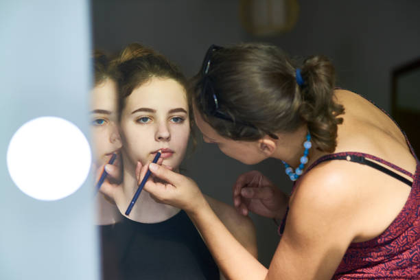 istock Artist lining lips of model 1357827735