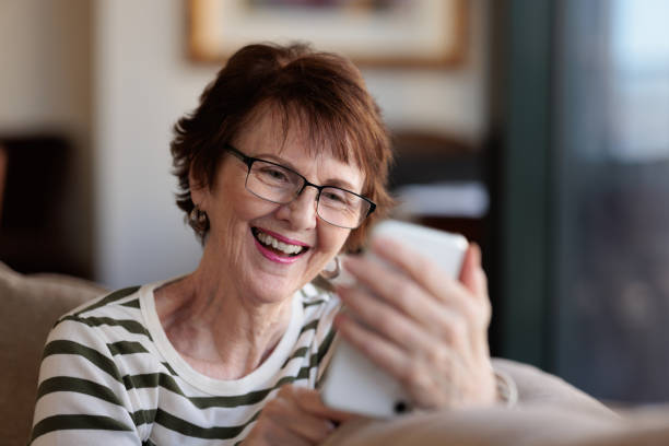 istock Smiling woman using her phone 1357829248