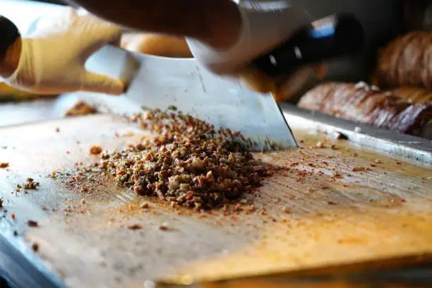 Turkish Street Food Kokorec rolls made with lamb bowel roasting in wood fired oven.