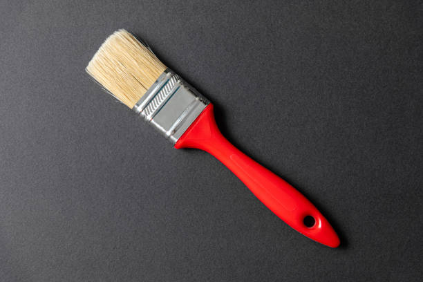Single wall paint brush on black stone background