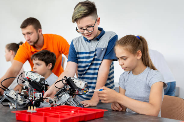 istock Kids working with teacher on their robot education project 1357832160
